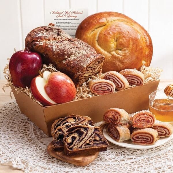 Rosh Hashanah gift basket with round challah, babka, rugelach, and apples with honey